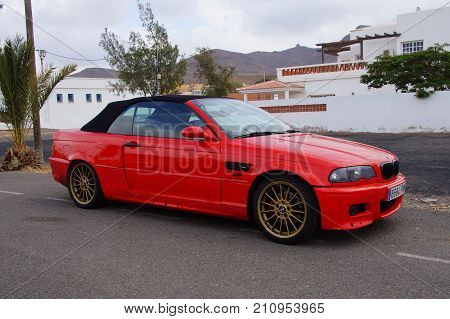 Las Playitas, Fuerteventura, Canary Islands, Spain - October 22, 2017: Red BMW 318 cabrio parked on e public parking lot in the city of Las Playitas.