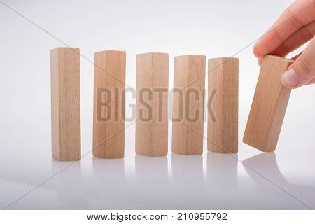 Hand Holding Wooden Domino