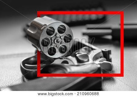 Red paper frame with .357 Caliber Revolver Pistol Revolver open ready to put bullets on leather furniture