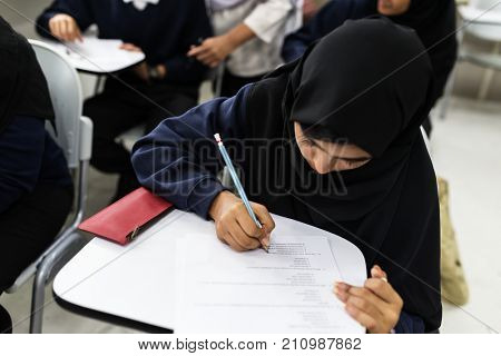 diverse muslim children studying in classroom