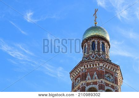 Bell Tower Of St. John The Theologian Monastery In The Background Of Clear Sky