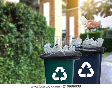 Man Hand Putting Plastic Reuse  For Recycling Concept Environmental Protection World Recycle