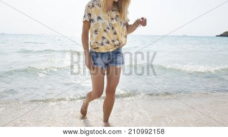 Woman walking on the beach summer vacation