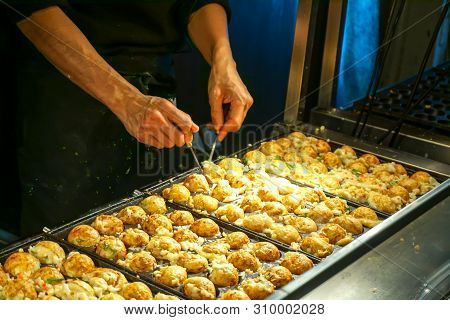 Hands Of Chef Cooking Japanese Snack Food 