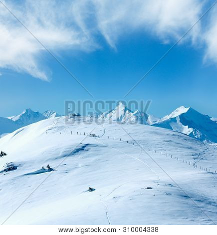 Cross On Winter Mountain Shneeberg Top And View Alps Peaks Behind, Hochkoenig Region, Austria