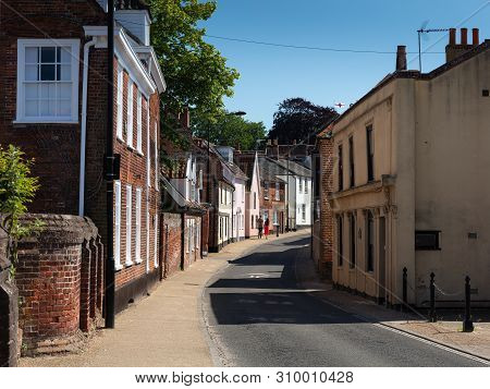 Beccles, United Kingdom - June 22, 2019: Couple Holding Hands Walking Along Northgate Street In Pret