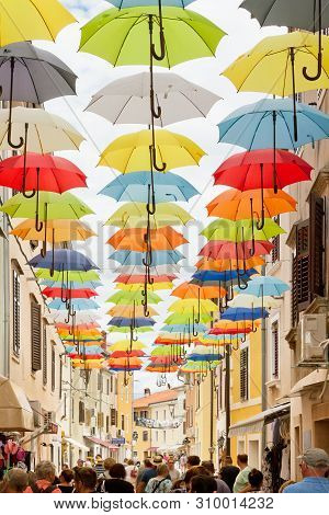 Novigrad, Istria, Croatia, Europe - September 3, 2017 - Tourists Walking Through An Alleyway With Co