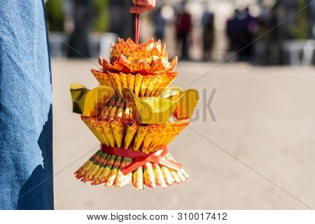 Nantou, Taiwan - FEB 8th, 2019: woman hold a lotus made by joss paper ready for burn at a Baohu Dimu Temple