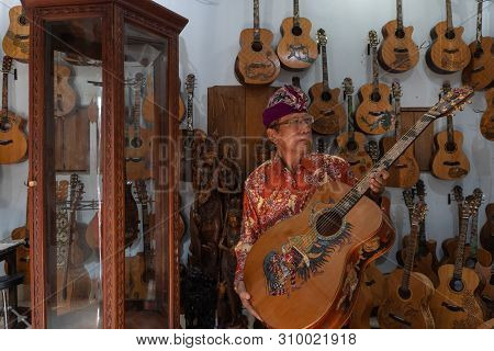 Gianyar,bali/indonesia-may 30 2019: I Wayan Tuges, The Owner Of The Tuges And Blueberry Carving Guit