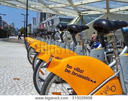 Brussels, Belgium - July 25, 2018. Villo Bicycles Parked In The Bicycle Sharing Station On Street. P