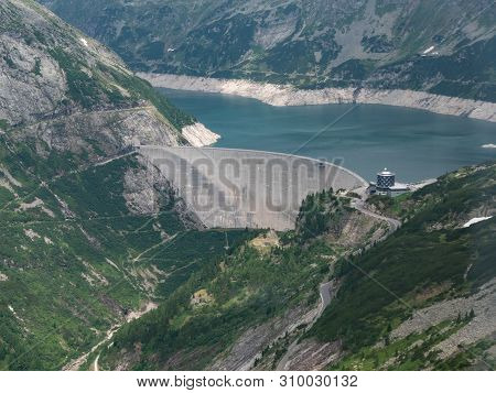 Dam And Reservoir Of A Hydroelectric Powerplant In Stunning Alpine Landscape - Maltastaudamm And Kol