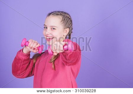 Beginner Dumbbell Exercises. Child Hold Little Dumbbell Violet Background. Sport For Teens. Easy Exe