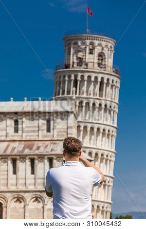 Pisa, Italy - April, 2018: Young Male Tourist Taking Pictures Of The Famous Leaning Tower Of Pisa