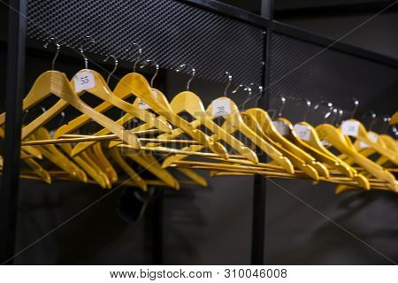 Bright Wooden Hangers With Numbers In Empty Cloakroom Or Checkroom Or Wardrobe
