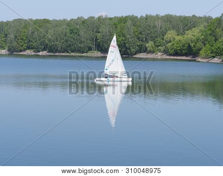 Goczalkowice, Poland On May 2019: White Yacht On Landscapes Of Artificial European Reservoir With Cl