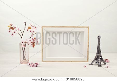 Mock Up With Empty Picture Frame, Decorative Effel Tower And Pink Tender Spring Flowers.