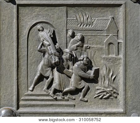 ZURICH, SWITZERLAND - JUNE 23, 2018: Ittingen Monastery in Frauenfeld is stormed and set on fire in July 1524., relief on the door of the Grossmunster (