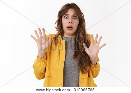 Girl Saw Ghost. Scared Young Silly Timid 25s Woman Raising Hands Surrender Stare Camera Frightened G