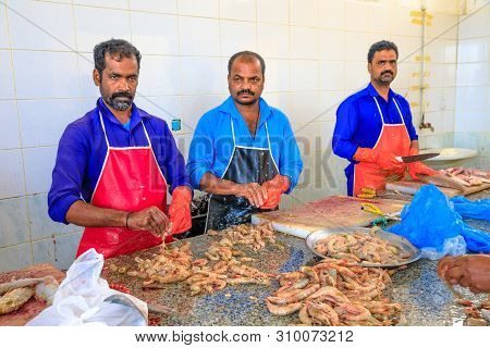 Al Khor, Qatar - February 23, 2019: Group Of Workers Cleans And Fresh Shrimp And Tuna Cuts Inside At