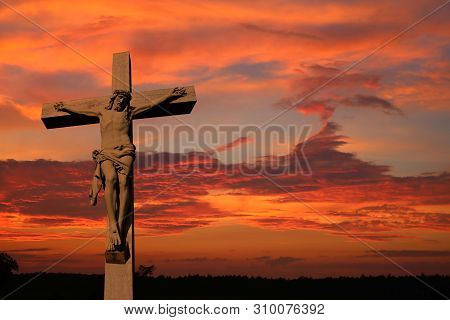 Concrete Crucifix Isolated Against Magnificent Sunset - Sacrifice, Atonement, Lent, Easter Concept