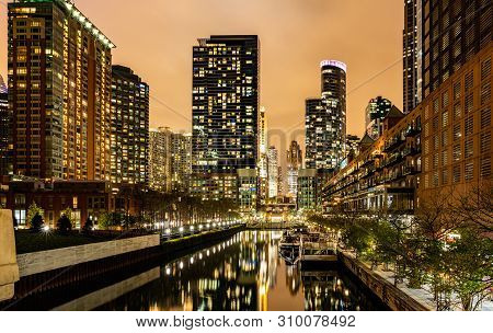 Chicago City Illuminated Buildings In The Evening. Reflections On The River Canal