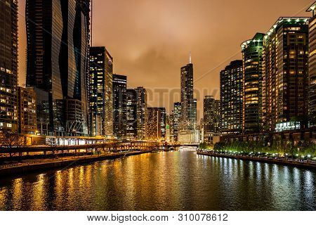 Chicago City Illuminated Buildings In The Evening. Reflections On The River Canal