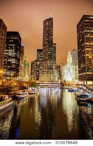 Chicago City Illuminated Buildings In The Evening. Reflections On The River Canal