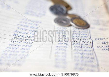 Hand-written Calculations And Coins. Bookkeeping (accounting). Economy. Financial Themes. Money Savi
