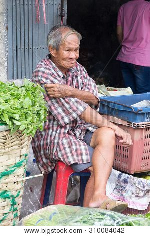 Bangkok, Thailand - July 9th 2015: Vegetable Vendor At Pak Khlong Talat Market Waiting For Business.