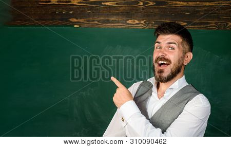 Teacher Giving Lesson To Students. Confident Male Teacher In Classroom. Education, High School And P