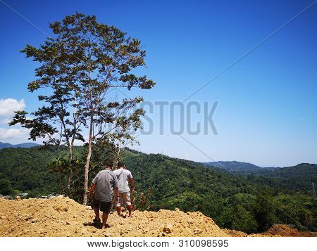 A Surveyor Is Measuring The Length Of The Highland In Penampang, Kota Kinabalu. Sabah, Malaysia. Bor