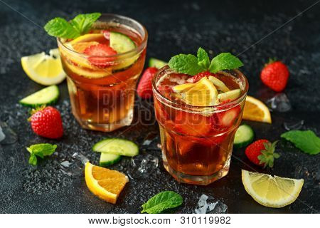 Refreshing Pimms Cocktail With Fruit And Vegetables On Rustic Black Table