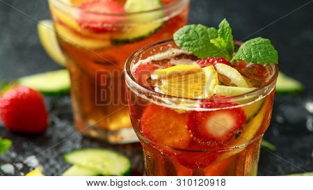 Refreshing Pimms Cocktail With Fruit And Vegetables On Rustic Black Table