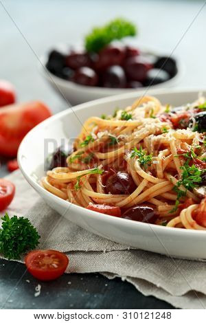 Pasta Alla Puttanesca With Garlic, Olives, Capers, Tomato And Anchois Fish