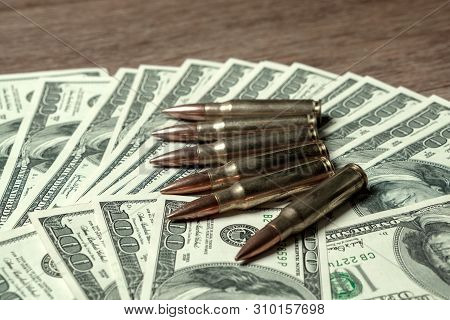6 Rifle Cartridges On Hundred Dollar Bills. Concept For Crime, Contract Killing, Paid Assassin, Terr