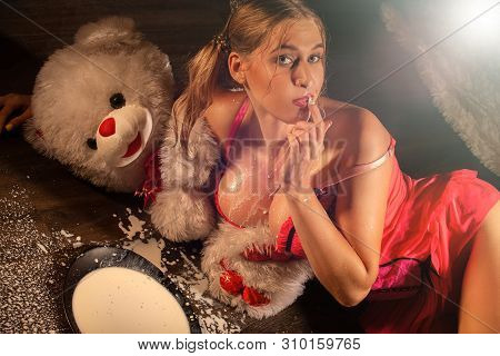 Girl In Lingerie Lying On Floor With Bowl Of Milk And Splashes