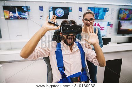 Gorgeous Youthful Hipster Couple Having Fun While Checking Out Vr In The Tech Store.