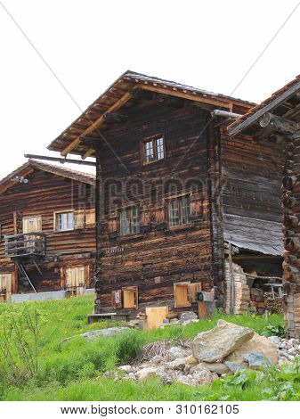 Old Timber Houses In Obermutten, Canton Of Grisons, Switzerland.