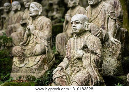 groups of buddhist arhat stone statue in the garden