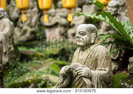 groups of buddhist arhat stone statue in the garden
