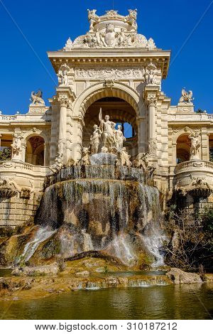 Marseilles, France, March 2019, close up of the fountain known as “water castle” and sculptures of four large bulls and three women in the Palais Longchamp.