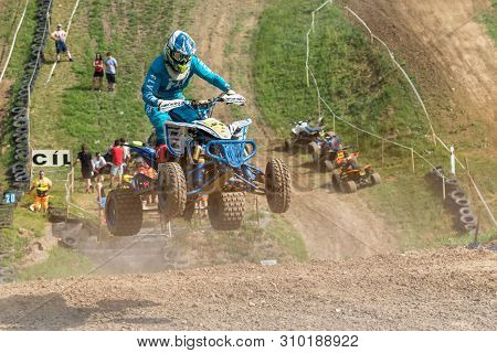 Brezova Nad Svitavou, Czech Republic - June 15, 2019: Closeup Dynamic Shot Of Quad Rider In Blue Jum