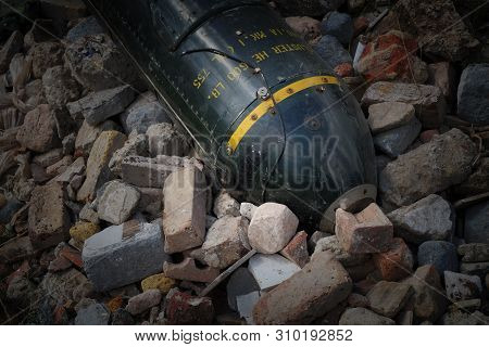 Unexploded Bomb In Rubble, Large Green Metal Missile