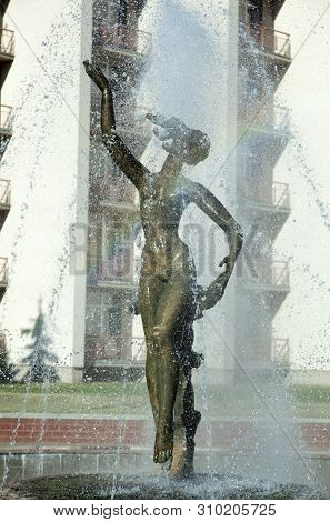 The Evening Sun And Water Droplets Creating A Rainbow Across The Fountain In Birstonas Resort Town (