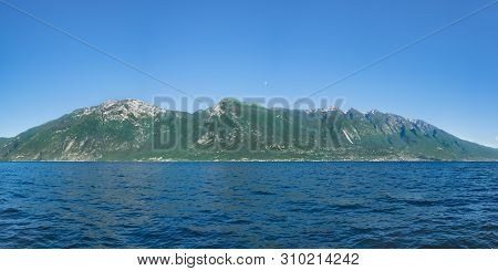 Beautiful View Of Monte Baldo And Lago Di Garda Coastline, Italy. View Of Malcesine And Nago-torbole