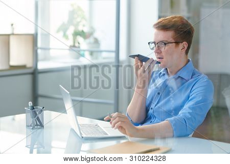 Contemporary office worker using voice message app