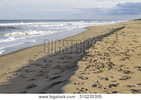 Footprints Cover The Sand At Sandbridge In Virginia Beach, Virginia.