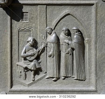 ZURICH, SWITZERLAND - JUNE 23, 2018: The 14-year-old Huldrych Zwingli making music in the Dominican Monastery in Bern, relief on the door of the Grossmunster (