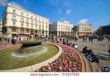 Madrid, Spain - March 22, 1012: tourists visiting the square known as Puerta del Sol, one of the neuralgic points of the city of Madrid.
