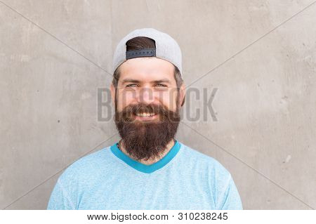 Beard Divides The Boys From The Men. Happy Caucasian Guy Wearing Beard On Grey Wall. Bearded Man Smi
